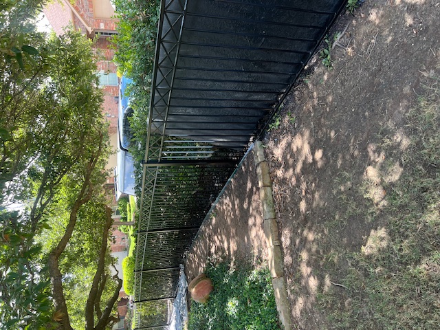 A view of a bridge over a stream in a park